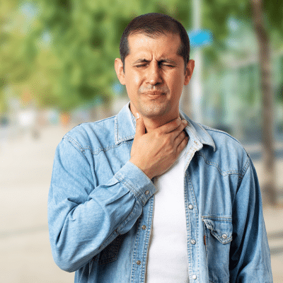 Man holding his throat in pain, representing GERD and throat irritation
