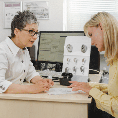 Hearing aid specialist talking to a patient