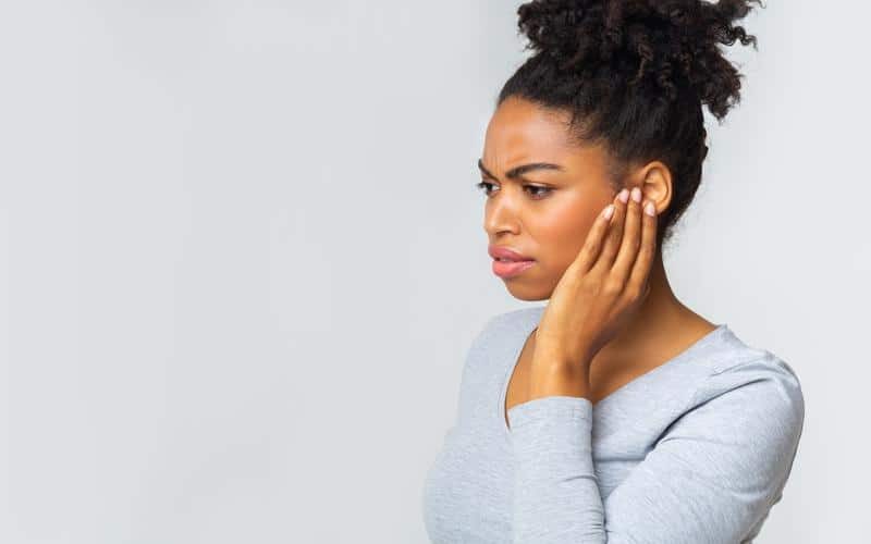 1760111445_woman-holding-ear-painful-e1668717563737