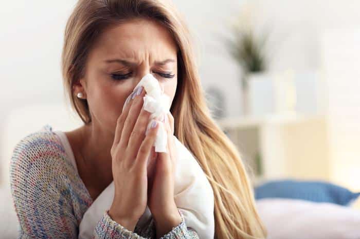 woman-with-allergies-blowing-nose